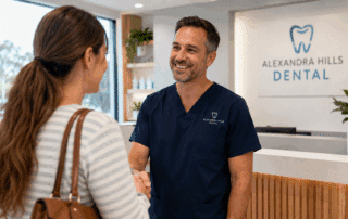 Friendly dentist welcoming a nervous patient into a modern dental clinic in Alexandra Hills.